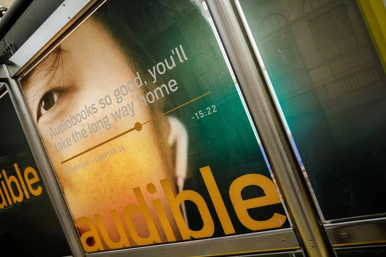 Close-up of an Audible bus shelter ad reading Audiobooks so good, you'll take the long way home.