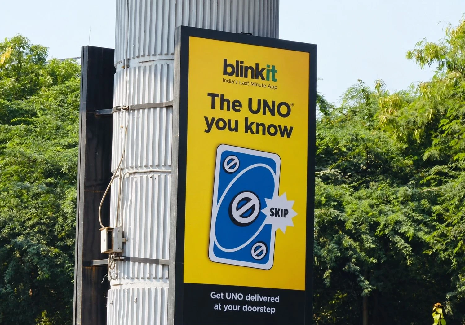 Blinkit and UNO metro pillar OOH ad featuring a Skip card and the line The UNO you know.