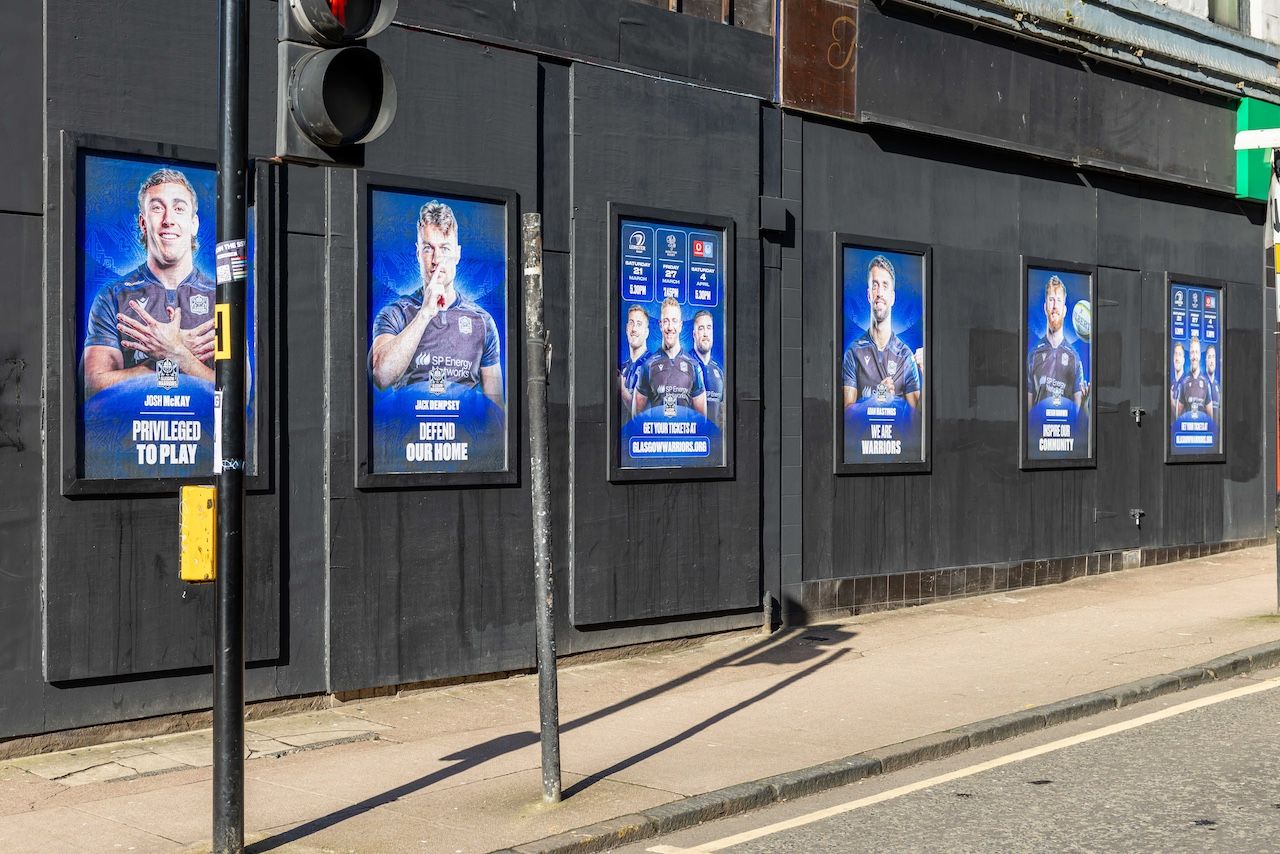 Row of OOH sports posters displayed across a Glasgow street
