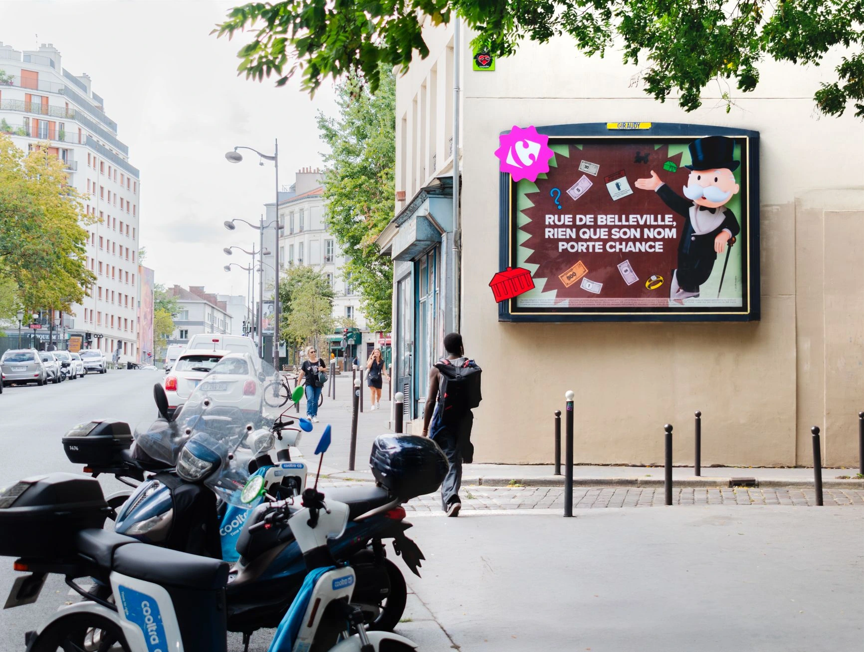 Carrefour Monopoly outdoor billboard in Paris on Rue de Belleville featuring Monsieur Monopoly and the line 'Rue de Belleville, rien que son nom porte chance'.