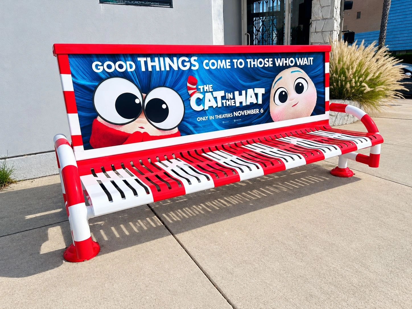 The Cat in the Hat bench with the message Good Things Come to Those Who Wait and red-and-white striped seat design.