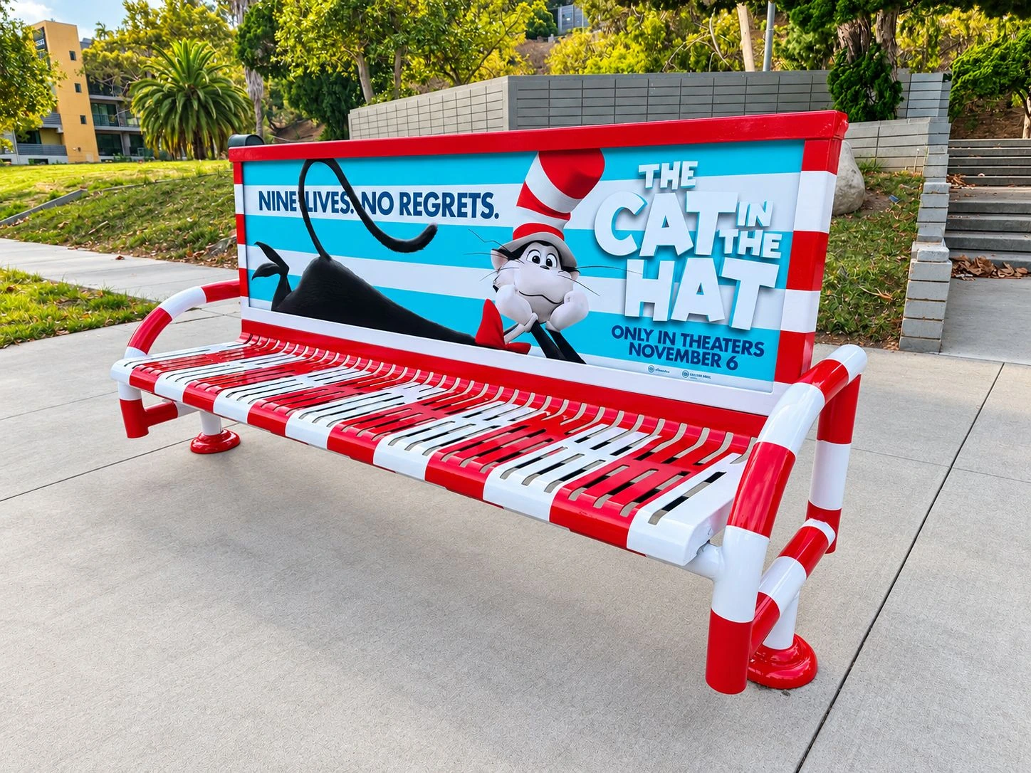The Cat in the Hat striped bench installation in Los Angeles with red-and-white rails and movie branding.