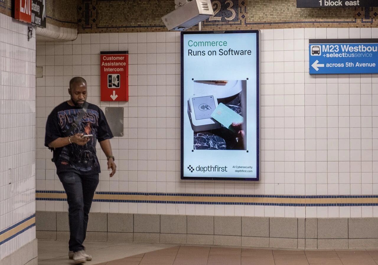 depthfirst digital subway advertisement in New York City with the headline Commerce Runs on Software and AI Cybersecurity branding.