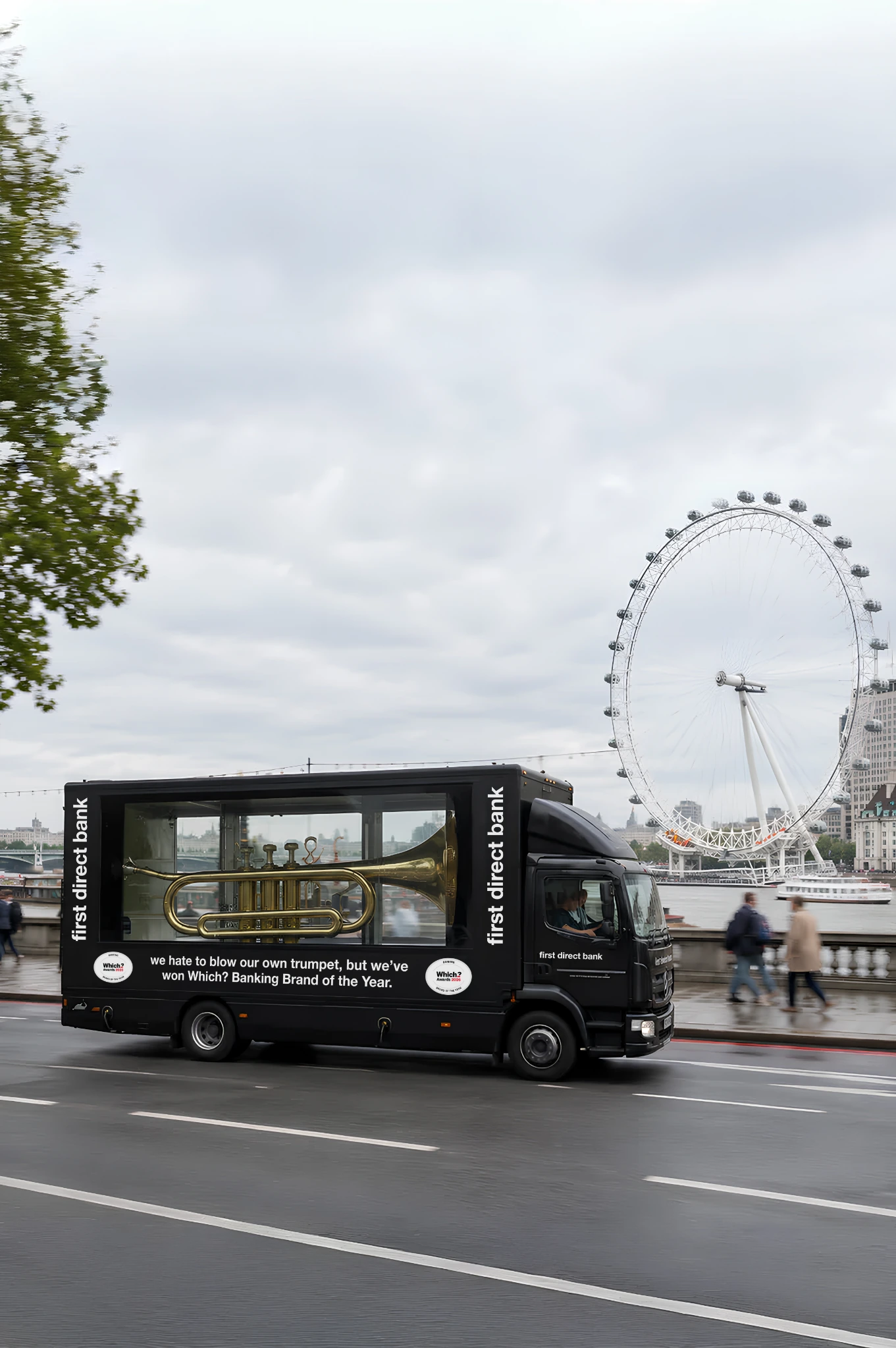 first direct branded mobile billboard with a giant trumpet driving beside the London Eye during the Blow Its Own Trumpet campaign.