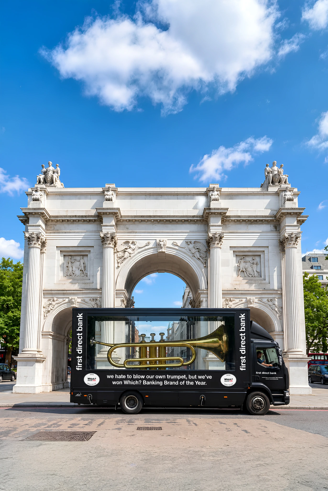 first direct branded glass-sided van carrying a giant trumpet near Marble Arch in London as part of its Blow Its Own Trumpet campaign.