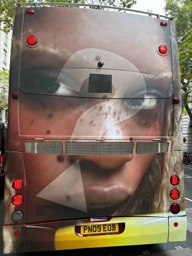Rear view of a London double-decker bus wrapped with a Guess Girls fashion portrait during the London campaign.