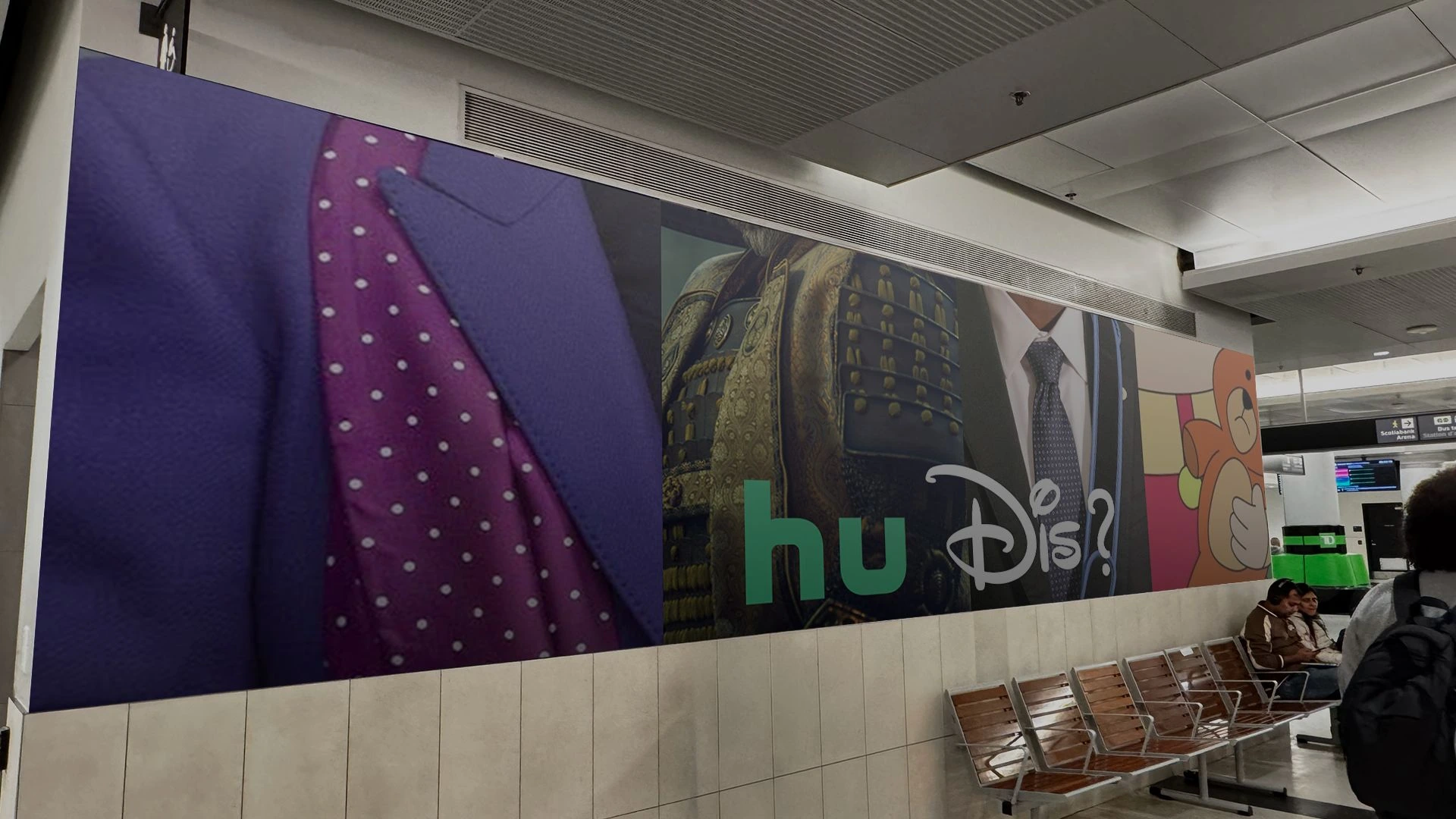 Large Hulu and Disney+ hu Dis creative installed inside a transit station waiting area.