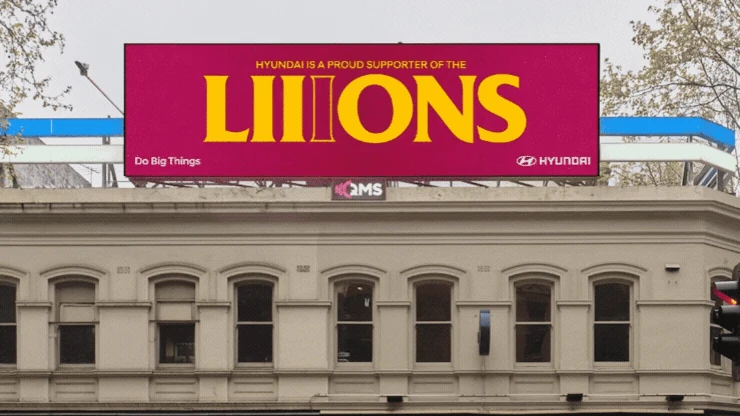 Hyundai digital OOH billboard supporting the Brisbane Lions with a modified Lions wordmark featuring three i letters to represent the club’s three-peat AFL Grand Final campaign.