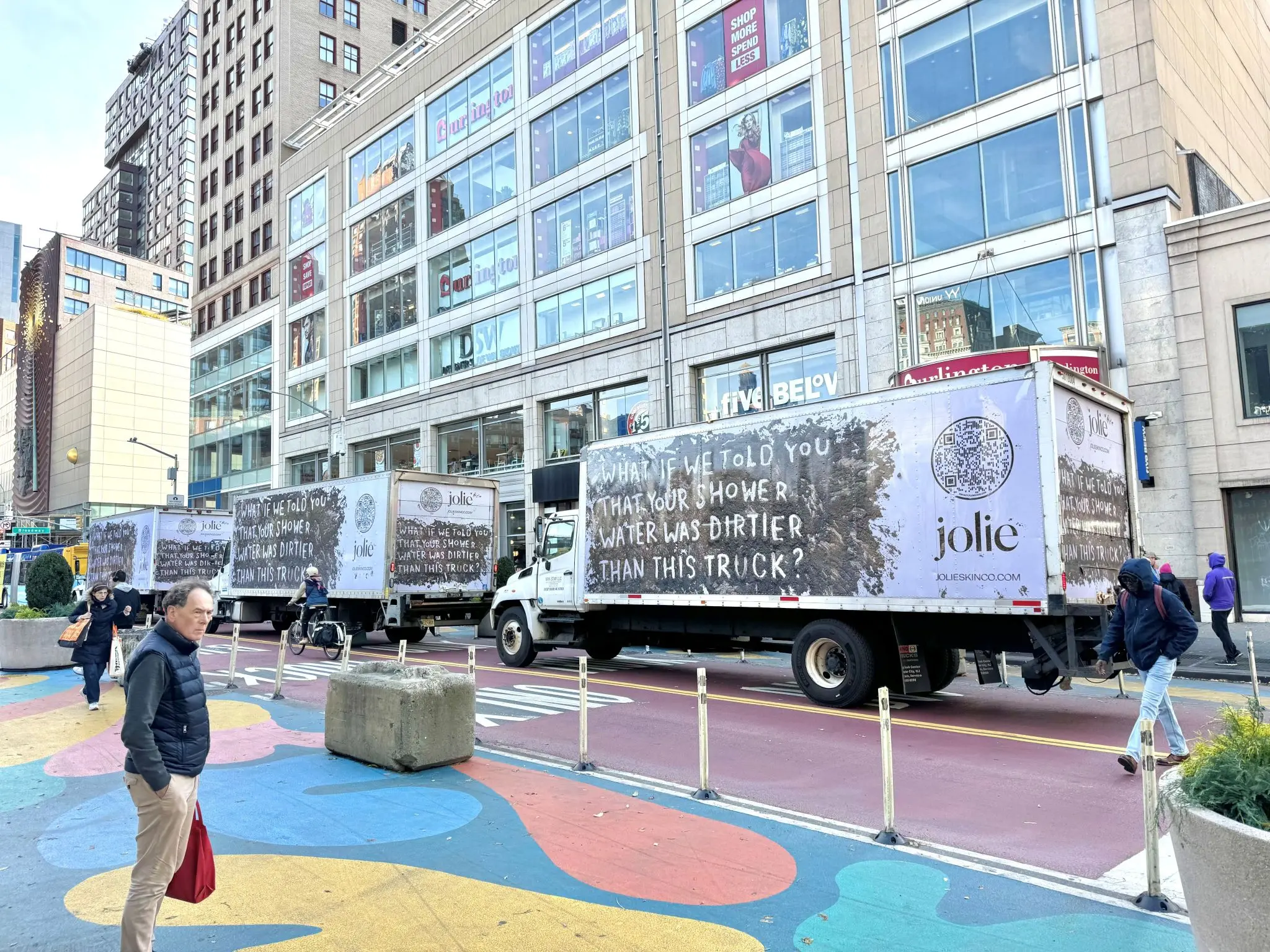 Three Jolie mobile billboard trucks driving through New York City with the message What if we told you that your shower water was dirtier than this truck?