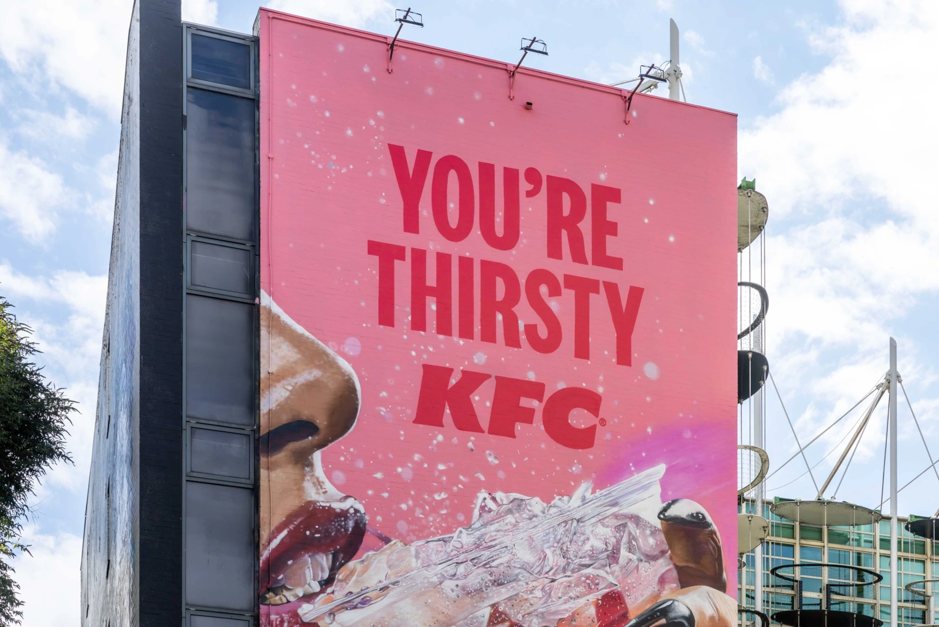 Close-up of the KFC Kwench Birmingham wallscape reading You’re Thirsty KFC with an oversized iced drink visual.