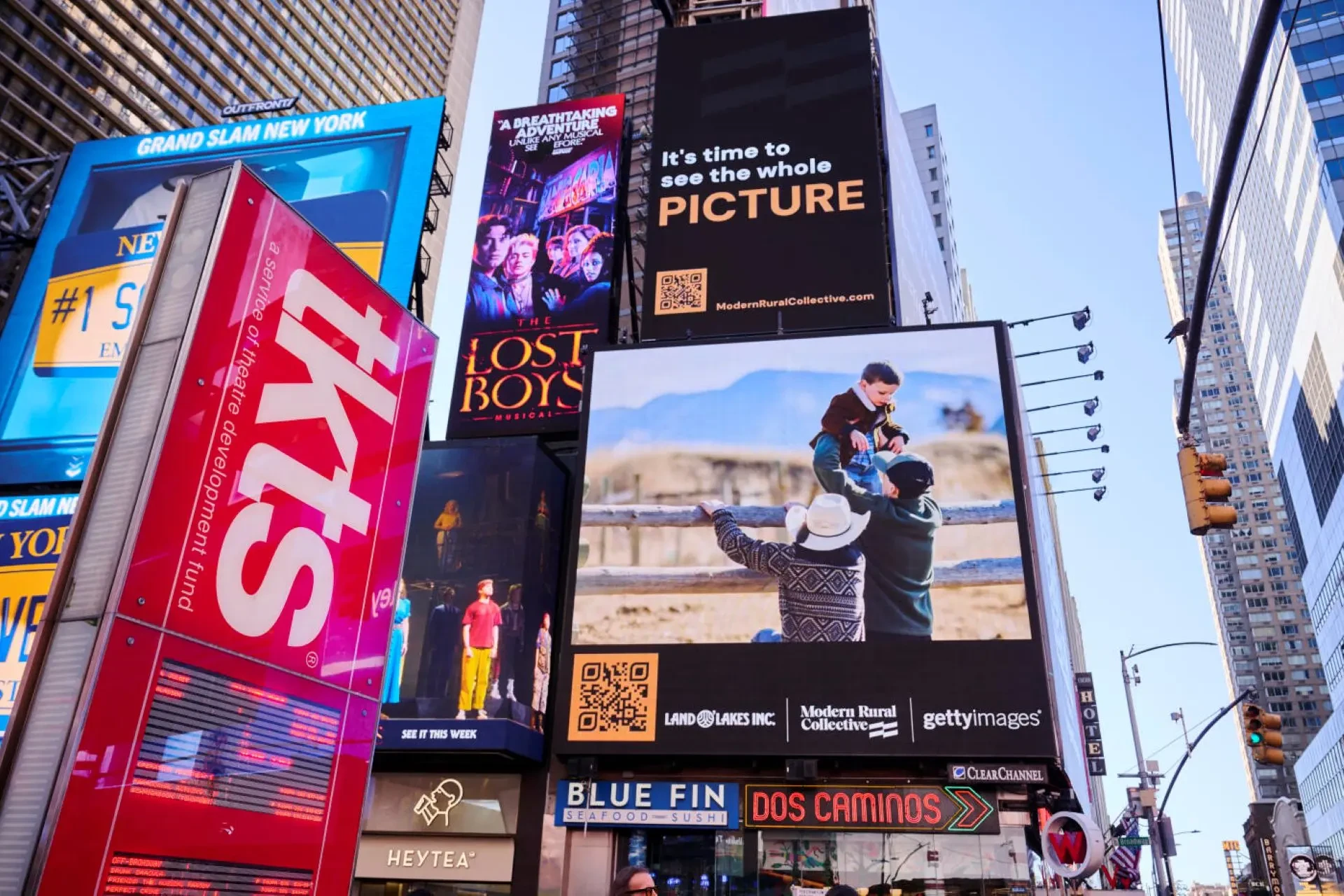Land O’Lakes Repicturing Rural campaign displayed on a large Times Square digital billboard in New York with photography of a contemporary rural family.