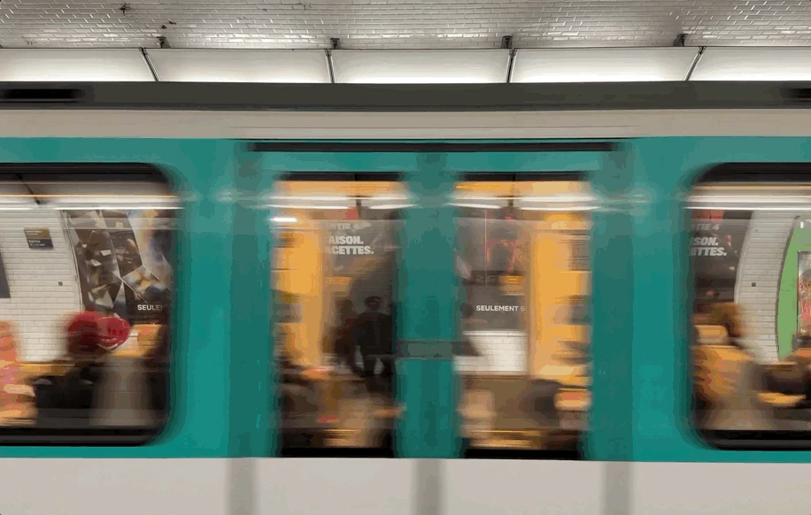 Paris Metro train passing Lupin Part 4 Netflix posters installed along the station platform.