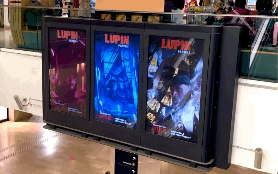 Three digital advertising screens promoting Lupin Part 4 with blue and red fractured reflections inspired by gemstones.