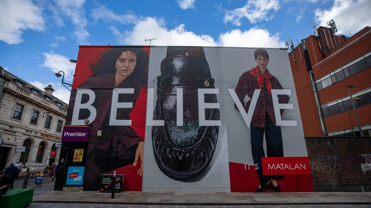 Close-up of the Matalan Believe It’s Matalan wallscape in Liverpool showing fashion imagery, a black shoe and the Matalan name added to the artwork.
