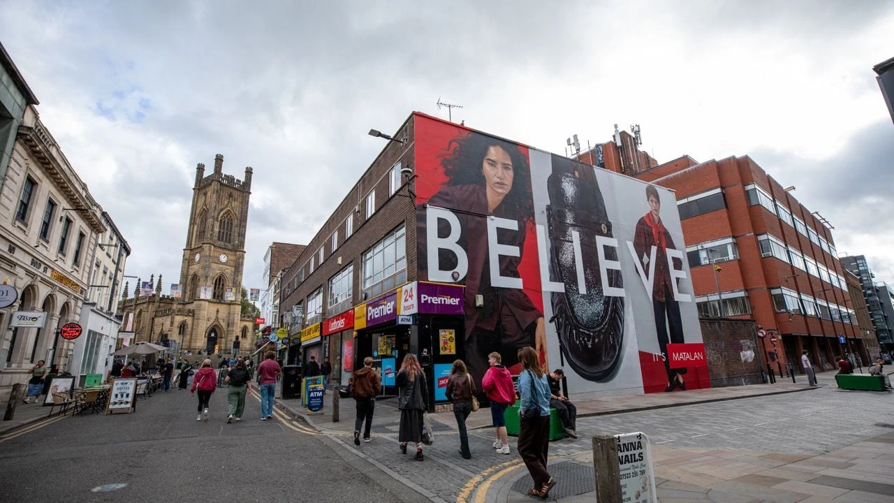 Large Matalan Believe It’s Matalan wallscape in Liverpool featuring fashion models, a giant shoe and the word Believe across a city-centre building.