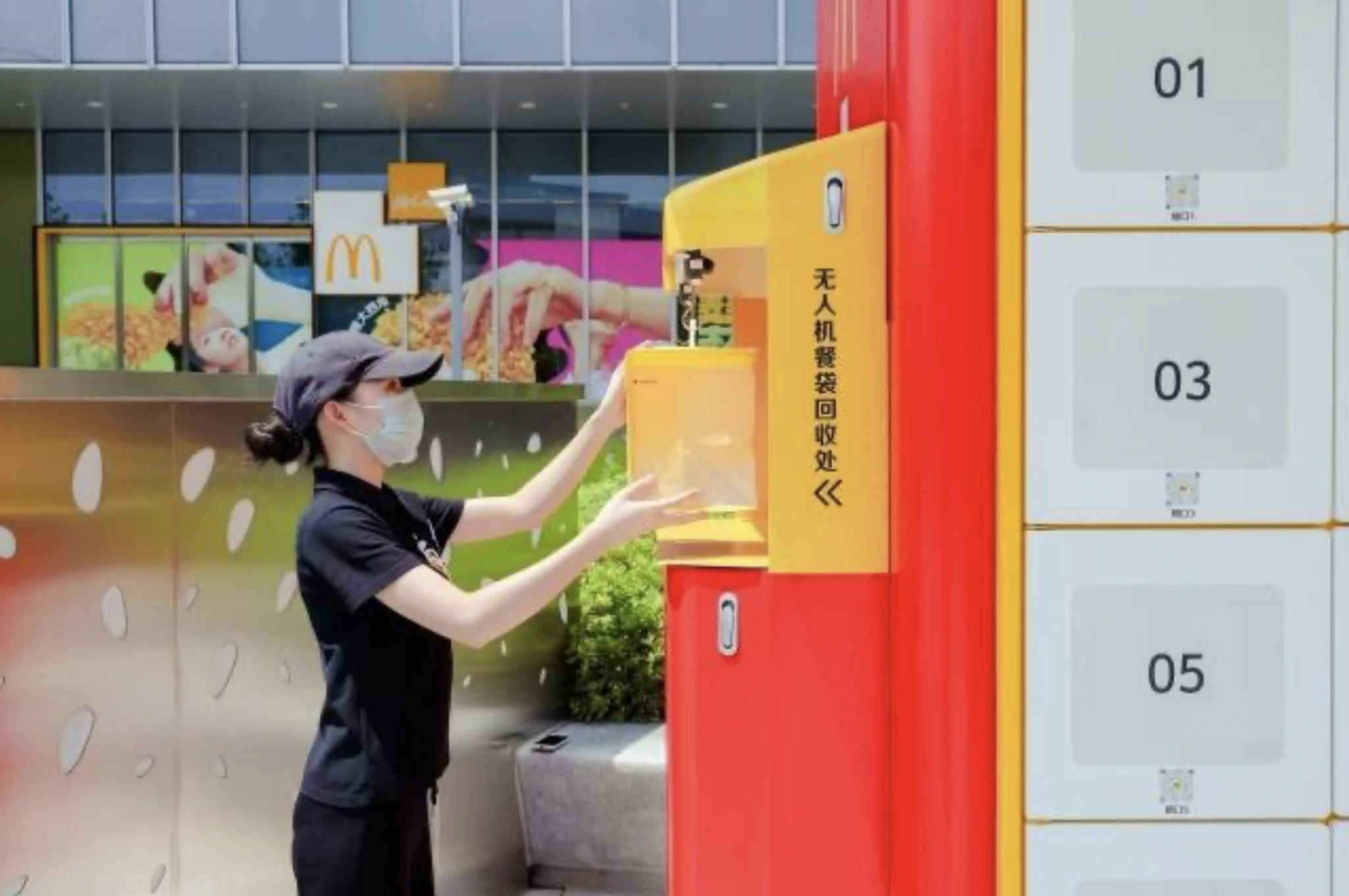 Customer retrieving a drone-delivered McDonald’s order from a kiosk in Shanghai.