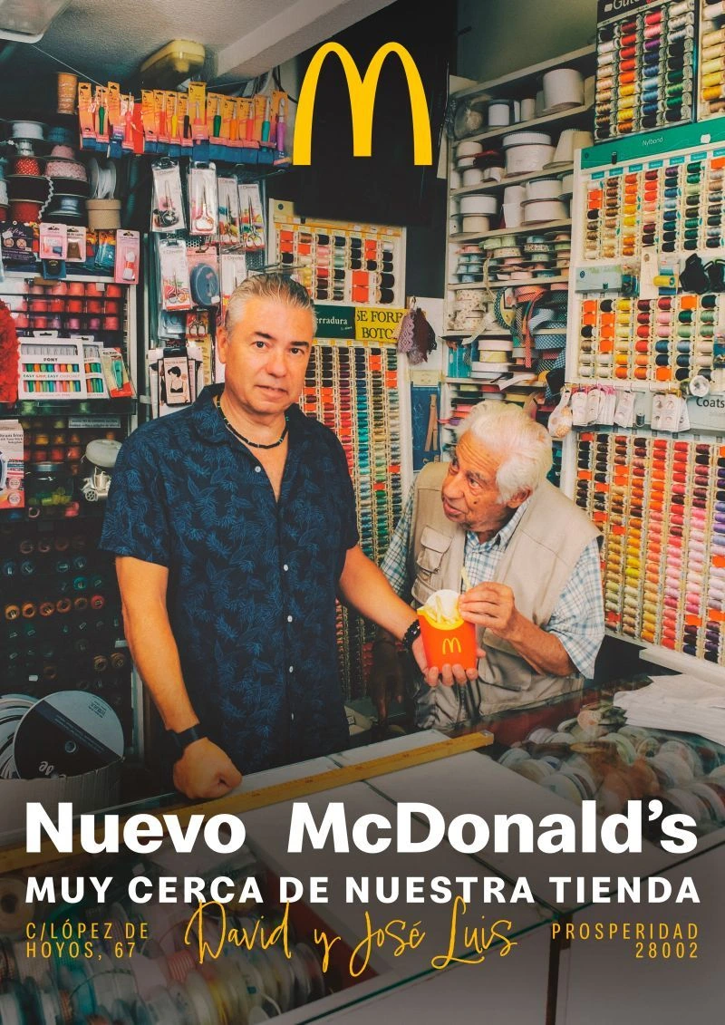 McDonald’s Prosperidad campaign creative featuring two local shopkeepers inside a long-standing neighborhood business in Madrid.