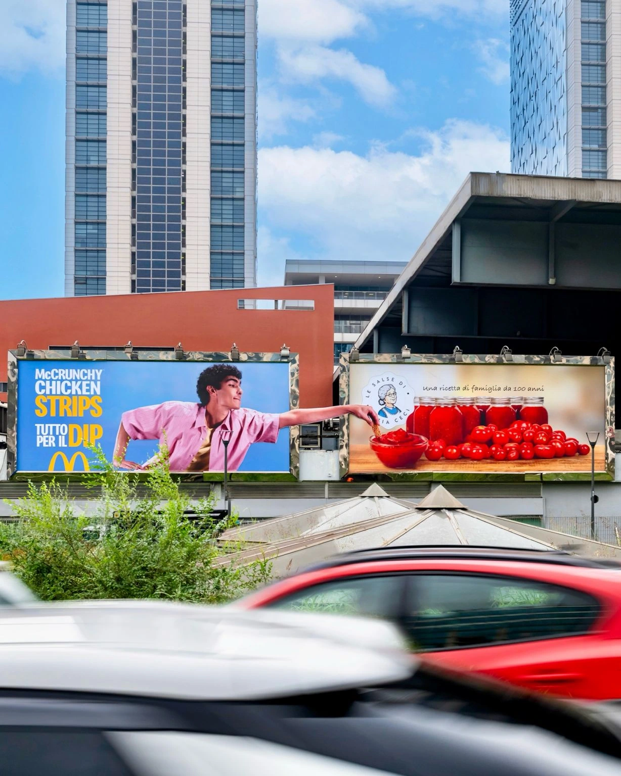 McDonald’s creative OOH installation in via Ferrari linking a billboard creative with a separate image of dipping sauce through an extended reaching arm.