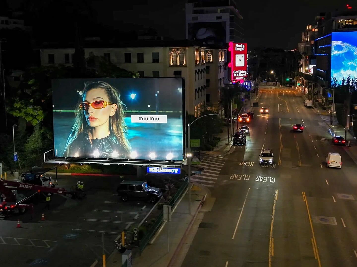 Miu Miu billboard illuminated at night on the Sunset Strip in Los Angeles.