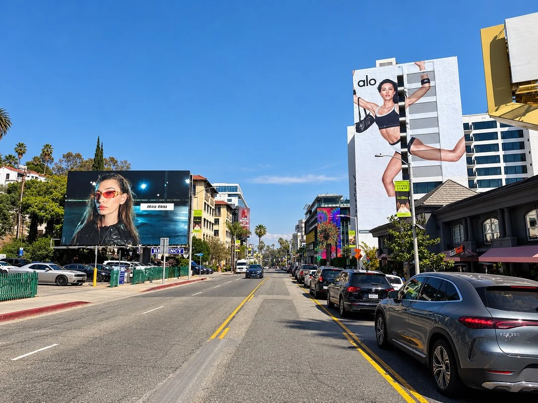 Miu Miu fashion billboard on the Sunset Strip in Los Angeles with surrounding luxury and lifestyle advertising.