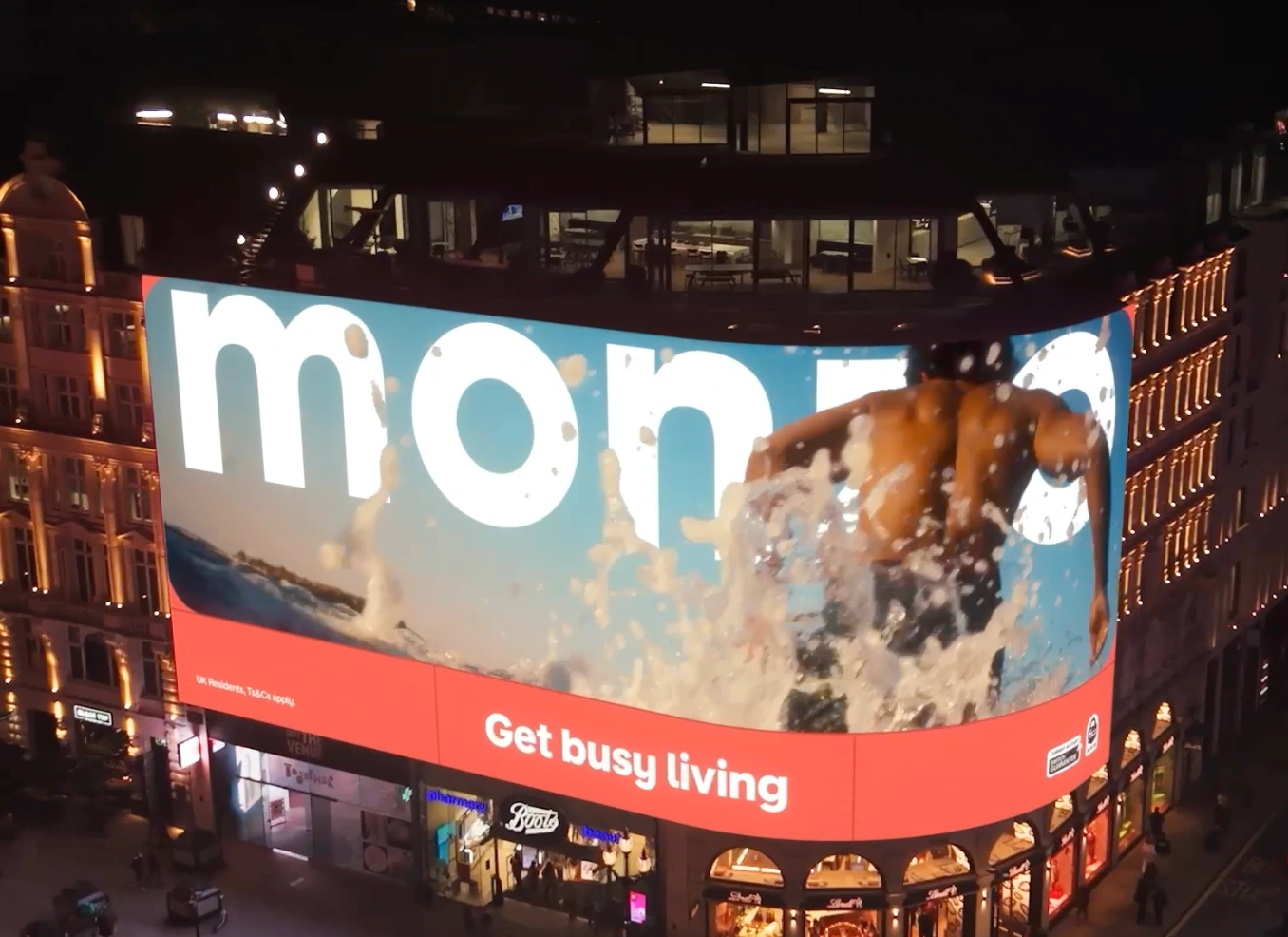 Monzo Get Busy Living large-format wallscape in London with a BMX rider appearing to jump out of a concrete skatepark scene.