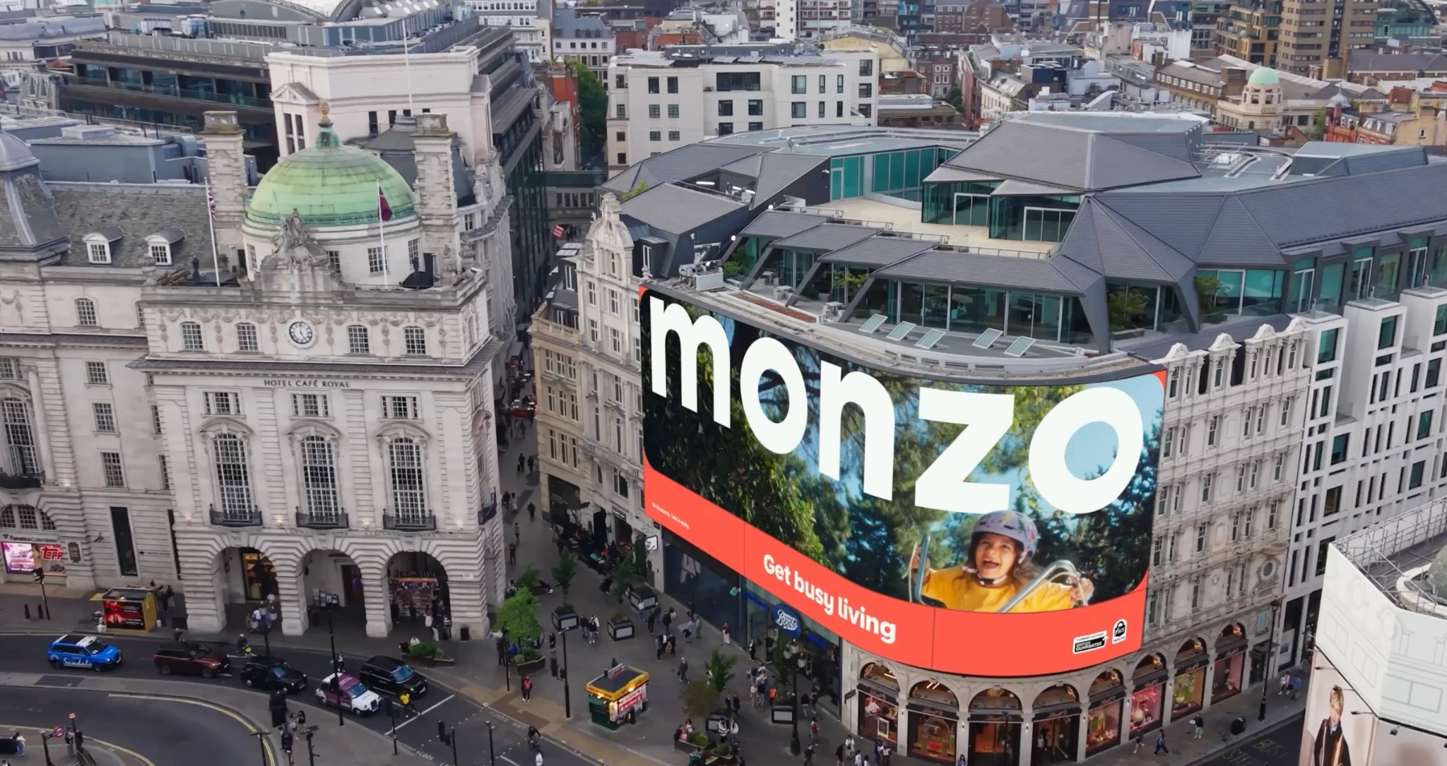 Monzo Get Busy Living creative displayed across Piccadilly Lights in London.