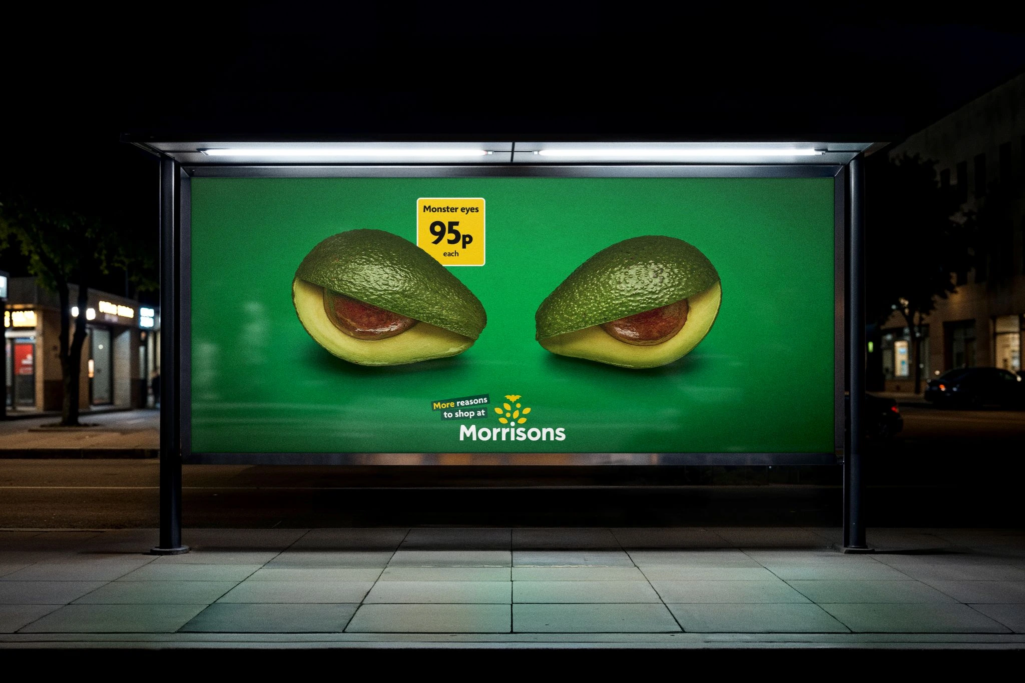 Morrisons bus shelter poster showing two avocado halves as monster eyes with a yellow price badge.
