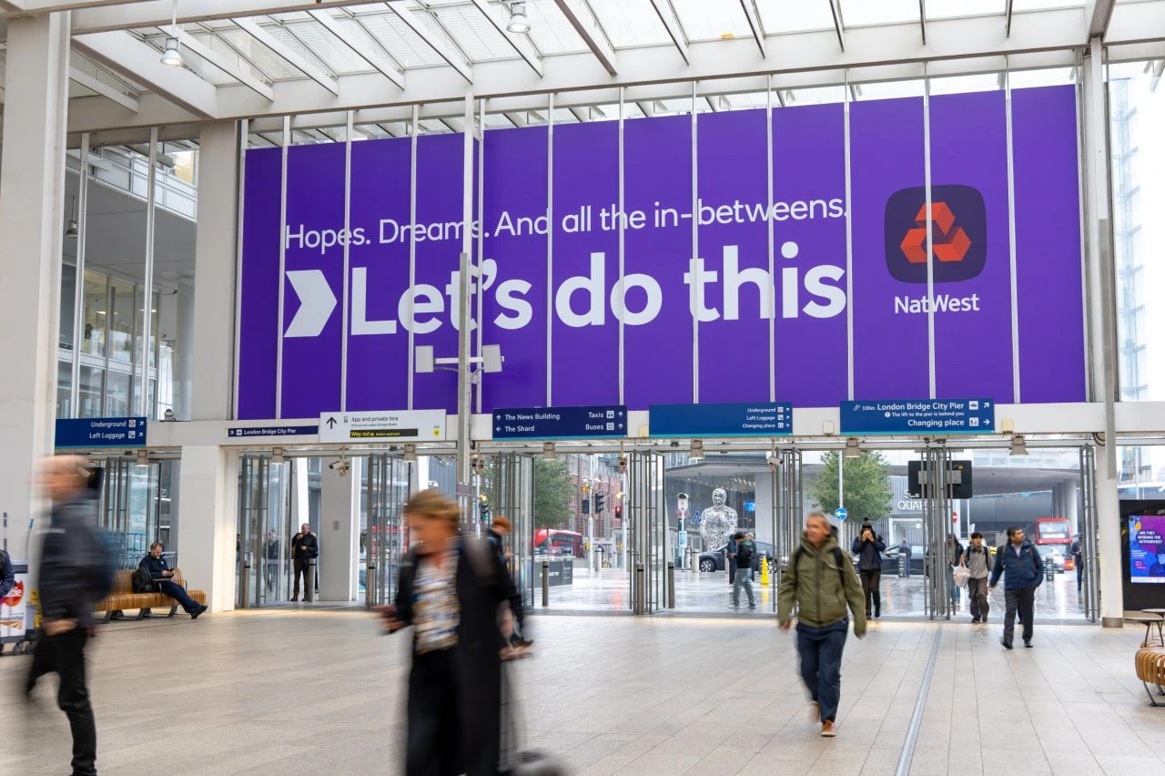 NatWest Let’s do this station domination at London Bridge with large purple branding across the entrance and the line Hopes. Dreams. And all the in-betweens.