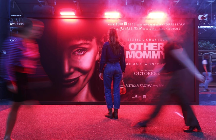 Other Mommy experiential billboard in London with red lighting, mist and pedestrians moving in front of the installation.