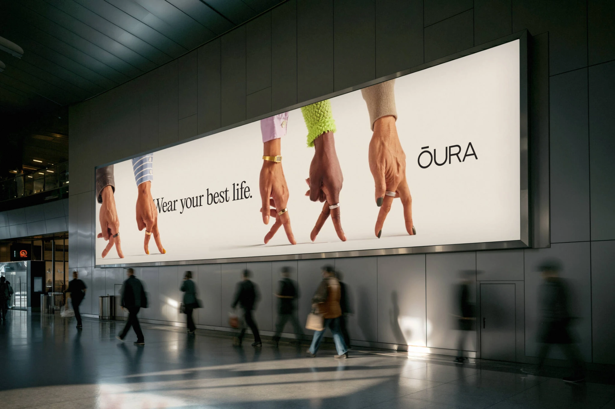 Oura Wear Your Best Life large-format transit OOH showing multiple hands wearing Oura rings.