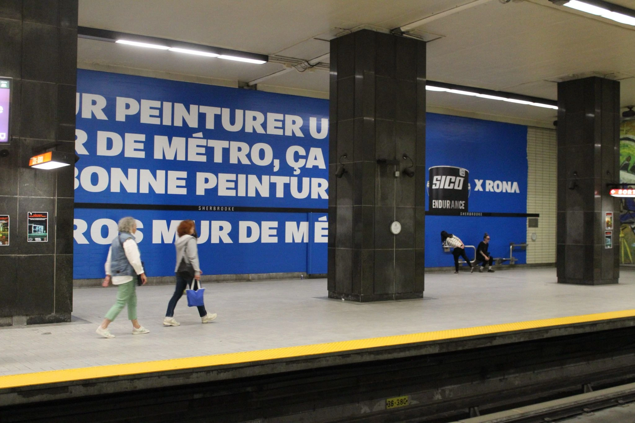 Large-format blue SICO x RONA wall takeover across a Montreal metro platform.