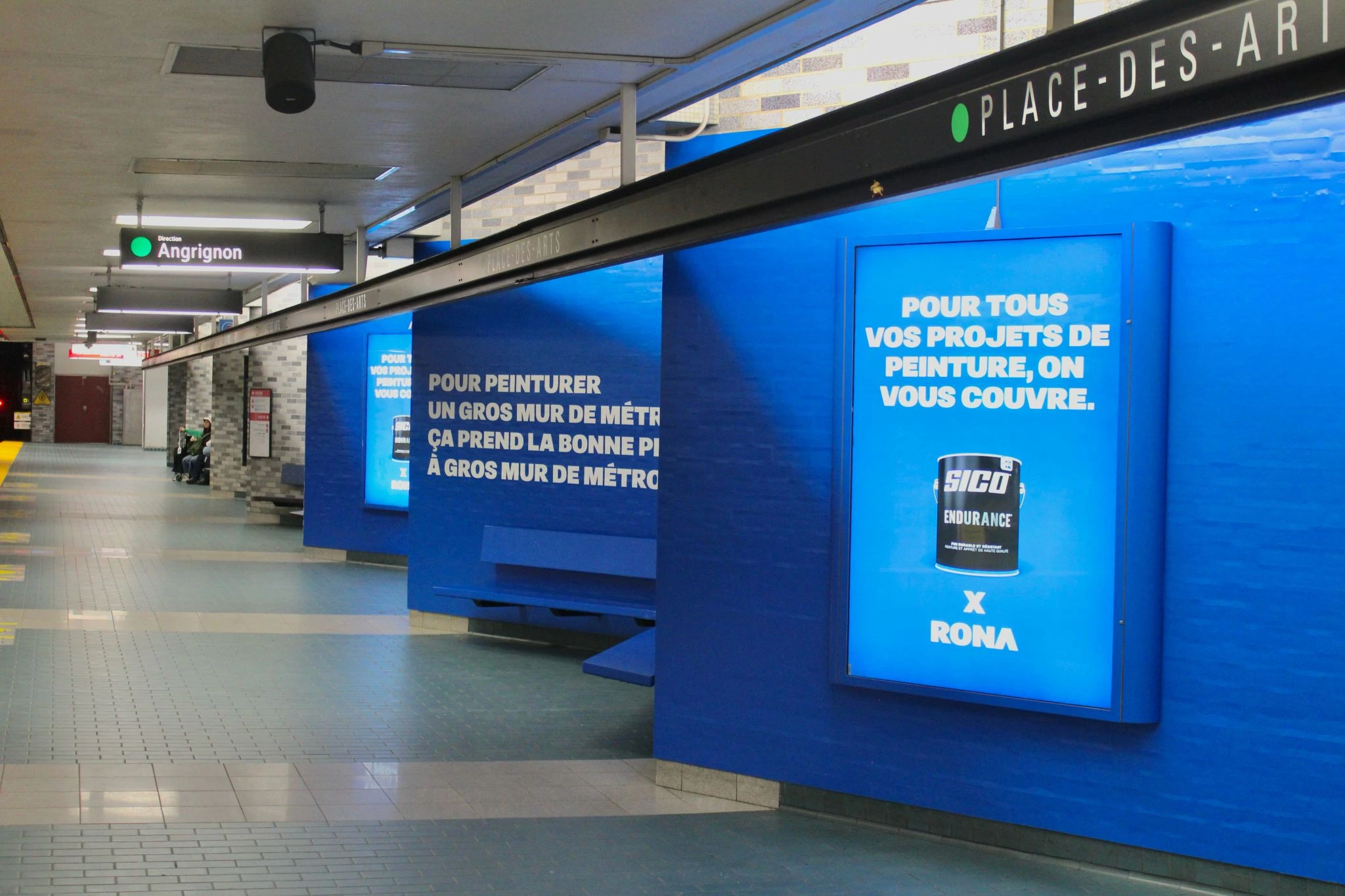 Blue SICO and RONA advertising takeover inside Place-des-Arts metro station in Montreal.