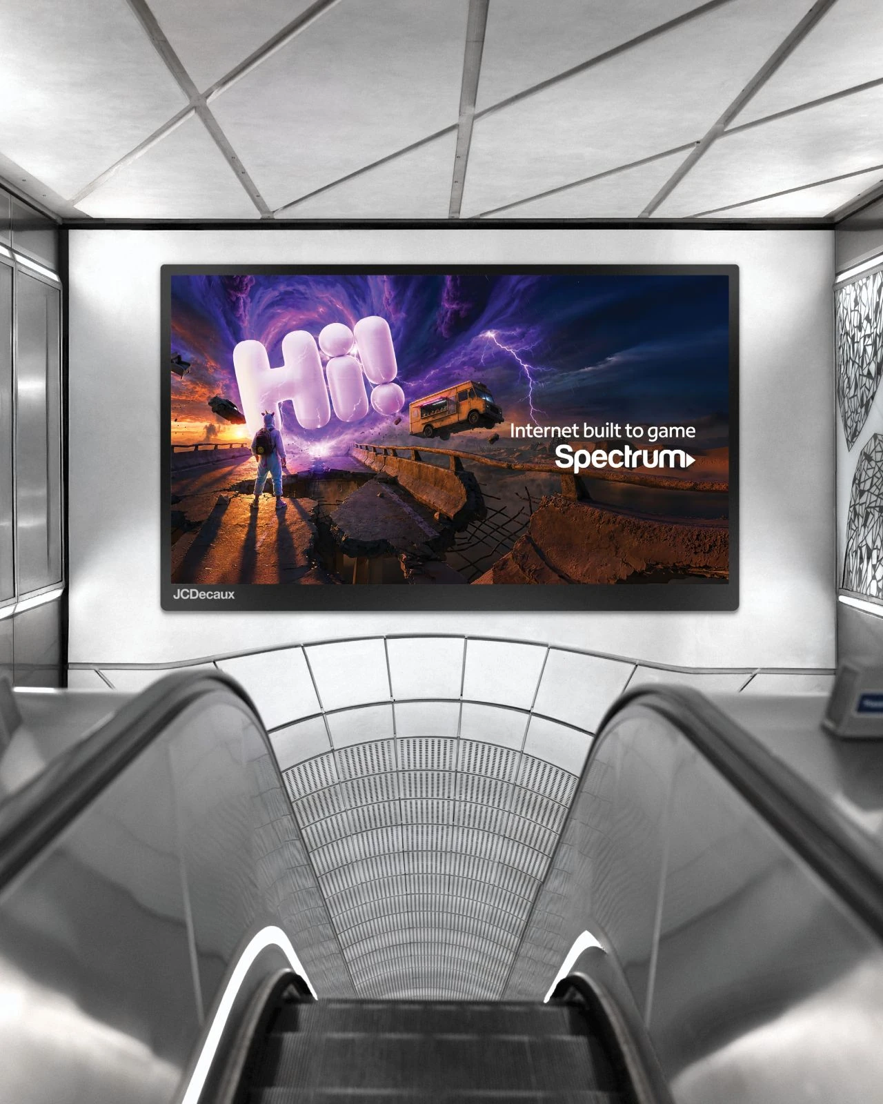 Digital Spectrum advertisement in a transit escalator setting featuring a giant inflatable Hi! in a dramatic gaming-inspired scene with the headline Internet built to game.