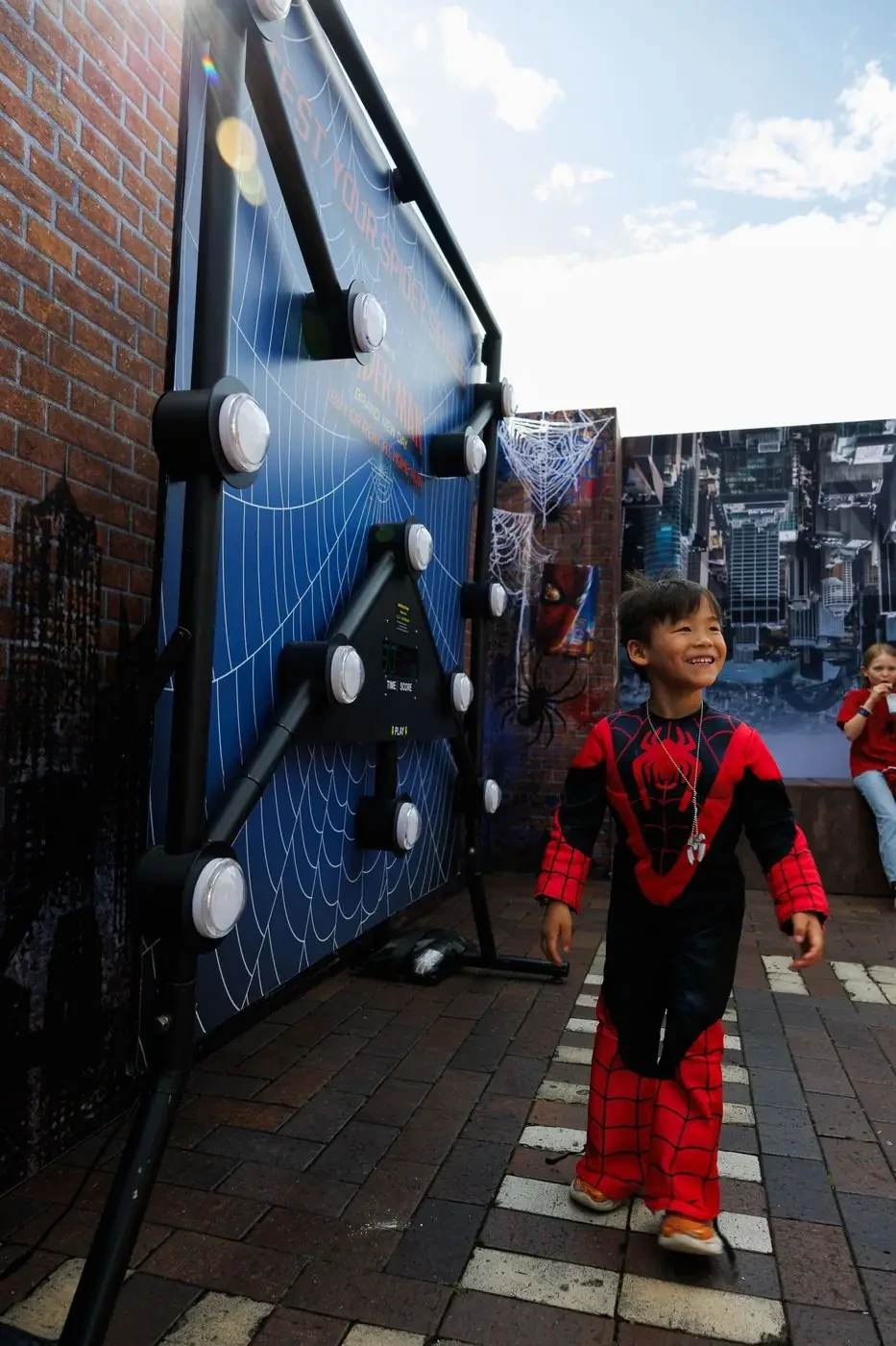 Child participating in the Spider-Man Spidey-senses reaction challenge at Circular Quay.