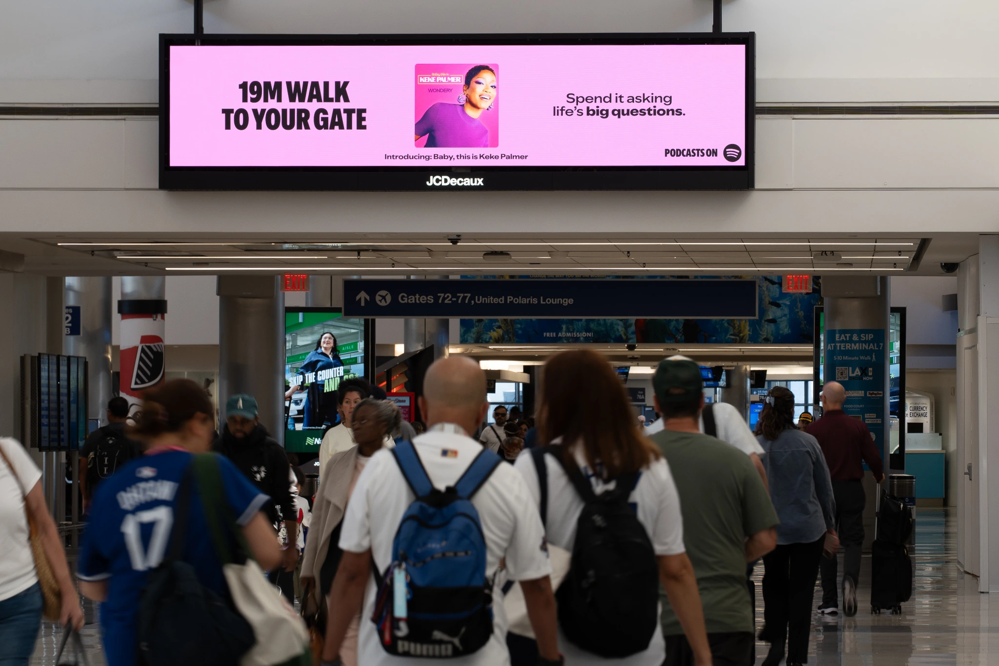 Spotify digital airport billboard promoting Baby, this is Keke Palmer with the line 19M walk to your gate.