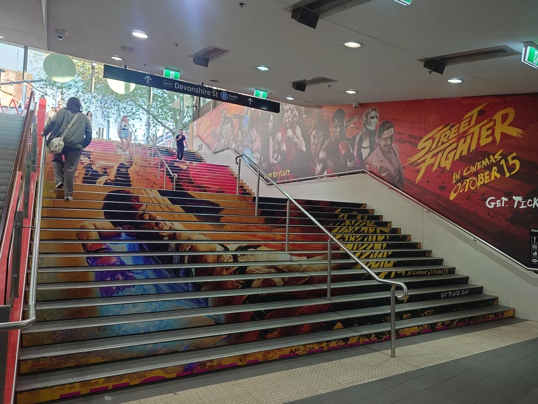 Street Fighter staircase and wall takeover inside a transit station.