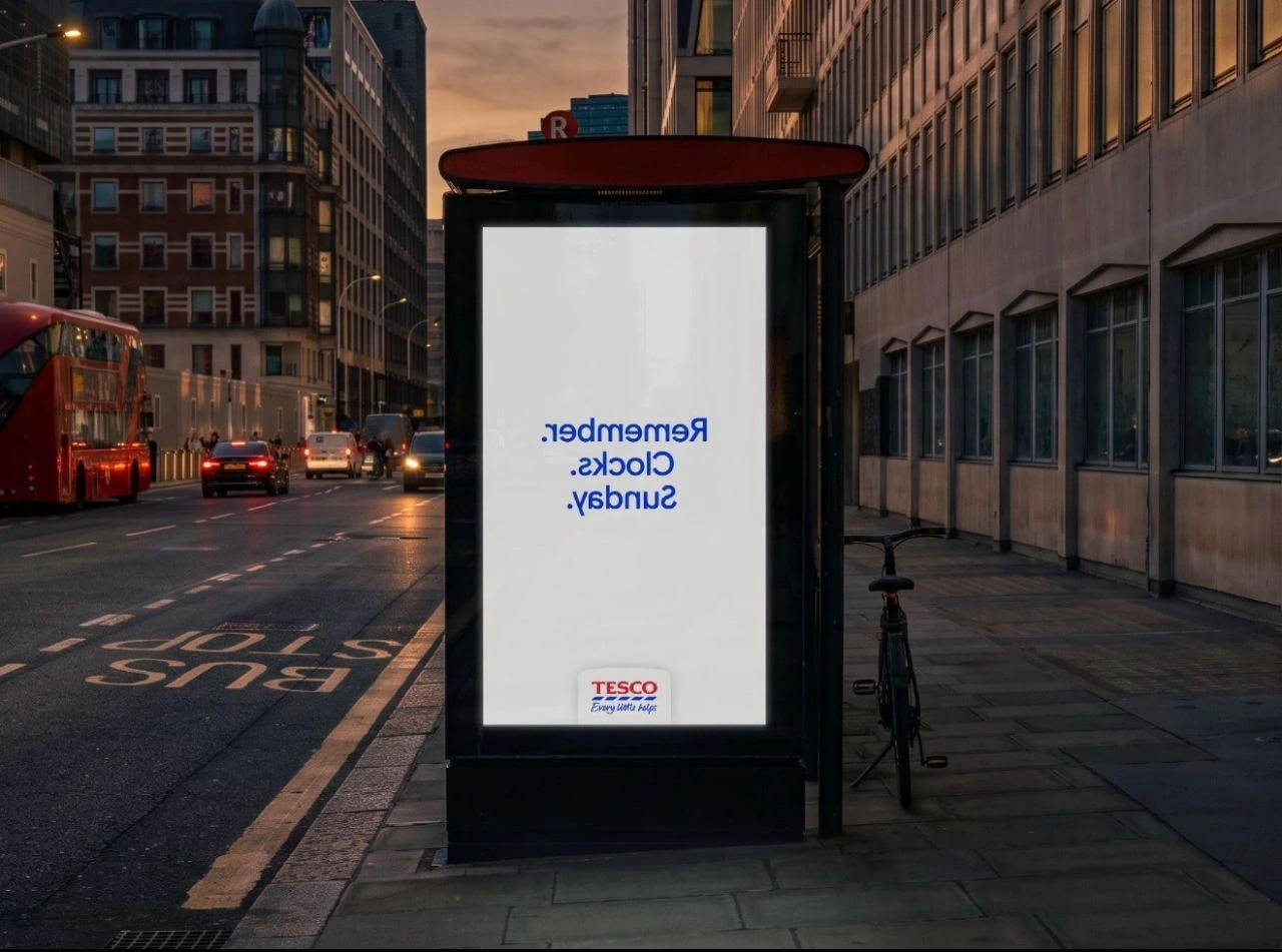 Tesco outdoor advertising display showing the words Remember Clocks Sunday written backwards ahead of the UK clock change.