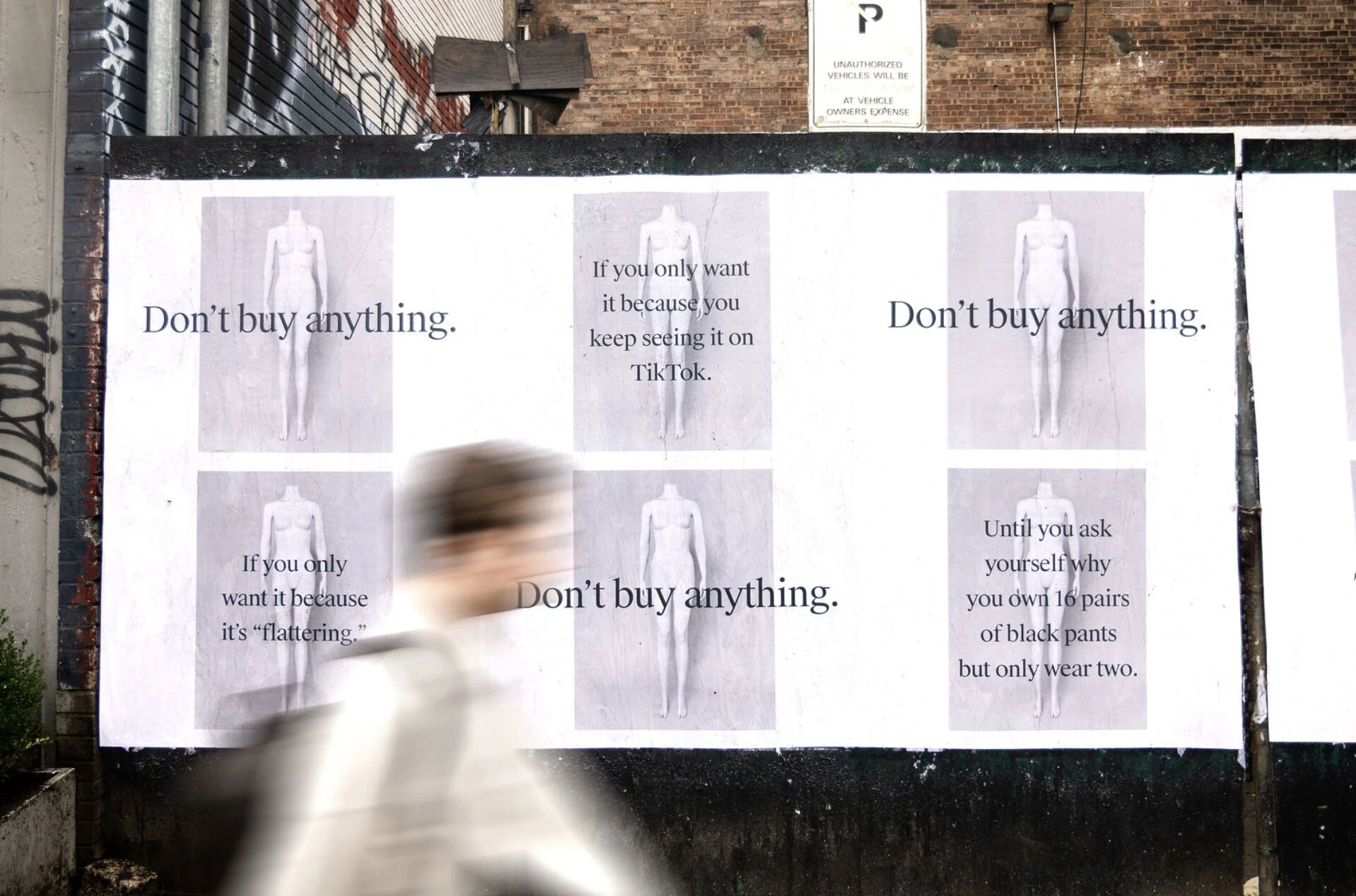 The RealReal wildposting wall featuring multiple Don’t buy anything messages about TikTok, flattering clothes and owning too many black pants.