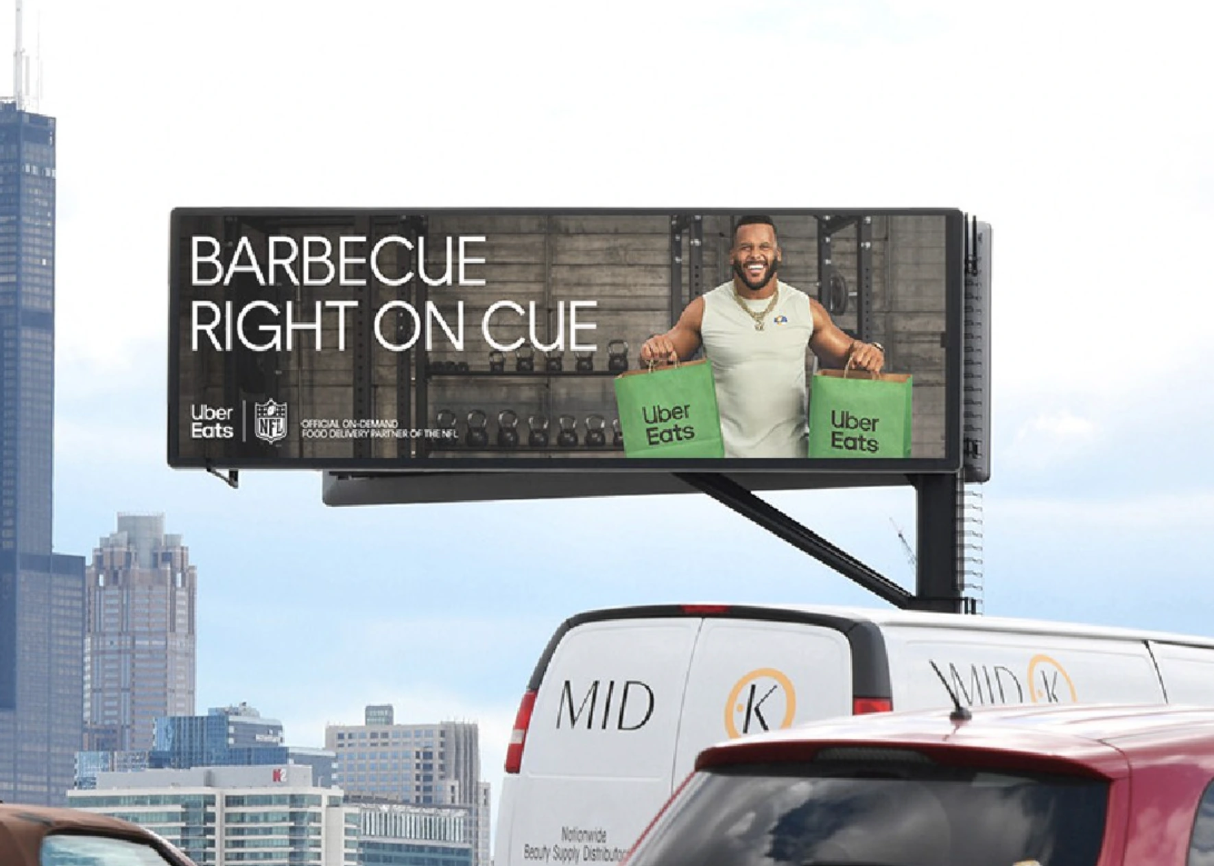 Uber Eats NFL billboard featuring a football player holding delivery bags and the message Barbecue Right on Cue.