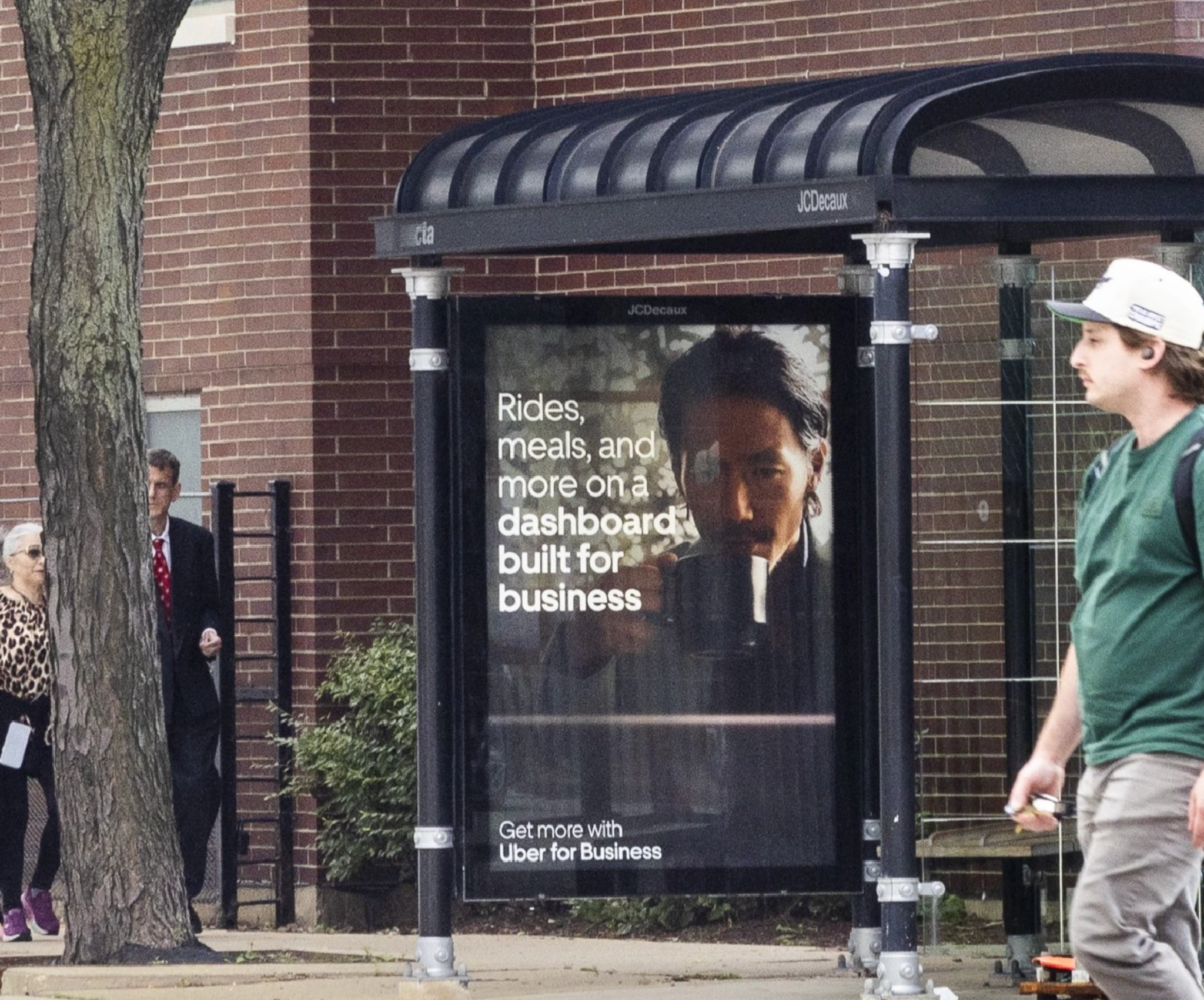 Uber for Business bus shelter advertising with the message Rides, meals, and more on a dashboard built for business.