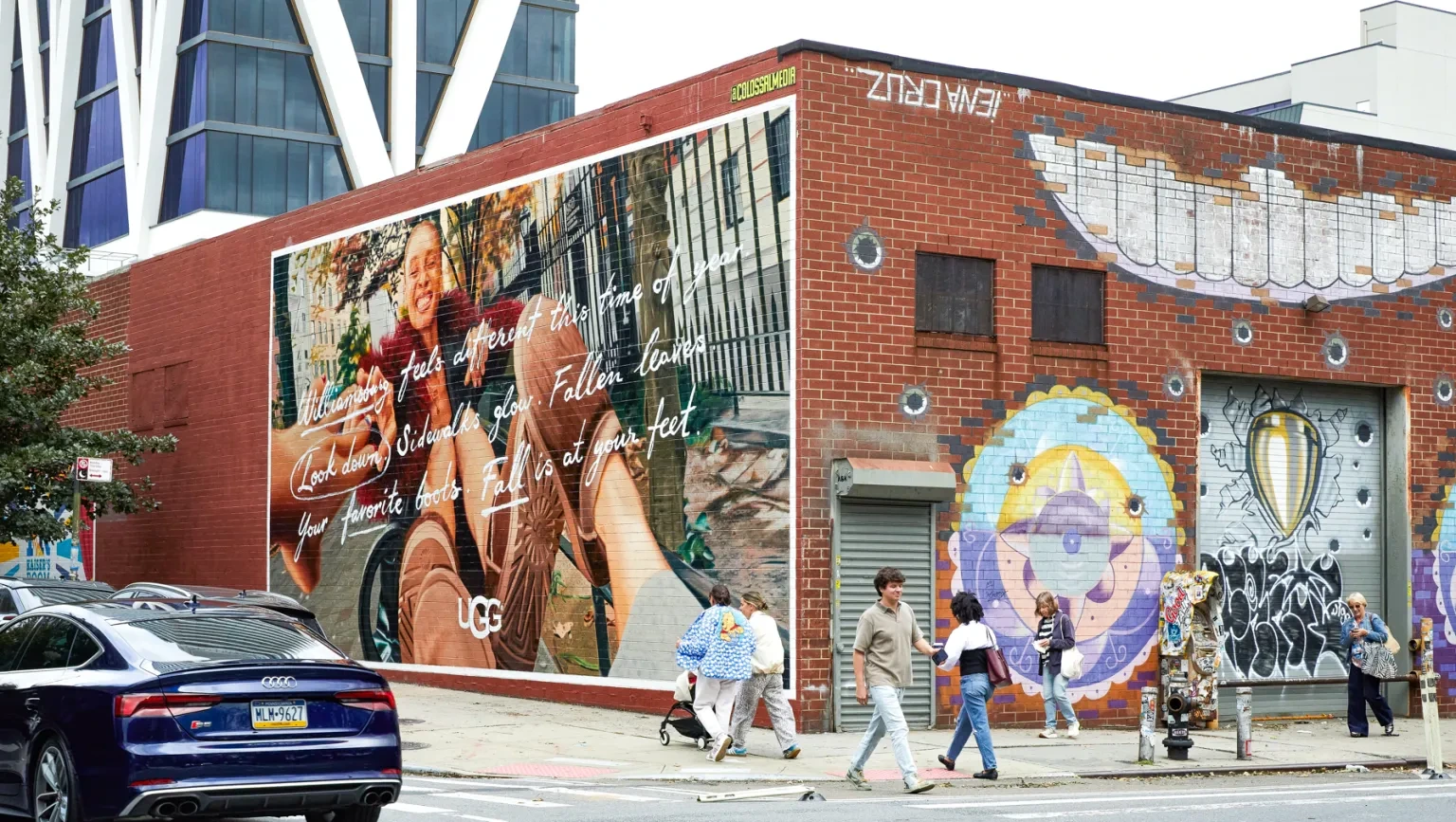 Large UGG mural in New York featuring fall lifestyle imagery and handwritten seasonal copy.