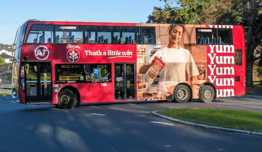 Vitasoy That’s a Little Win full bus wrap OOH campaign in New Zealand using bold red branding and product-led creative.
